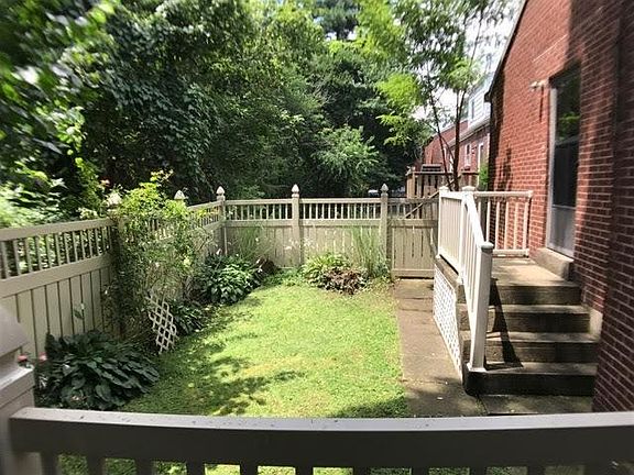 Fenced-in side yard by stream