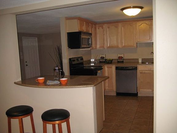 Kitchen with granite slab island and bar for entertaining