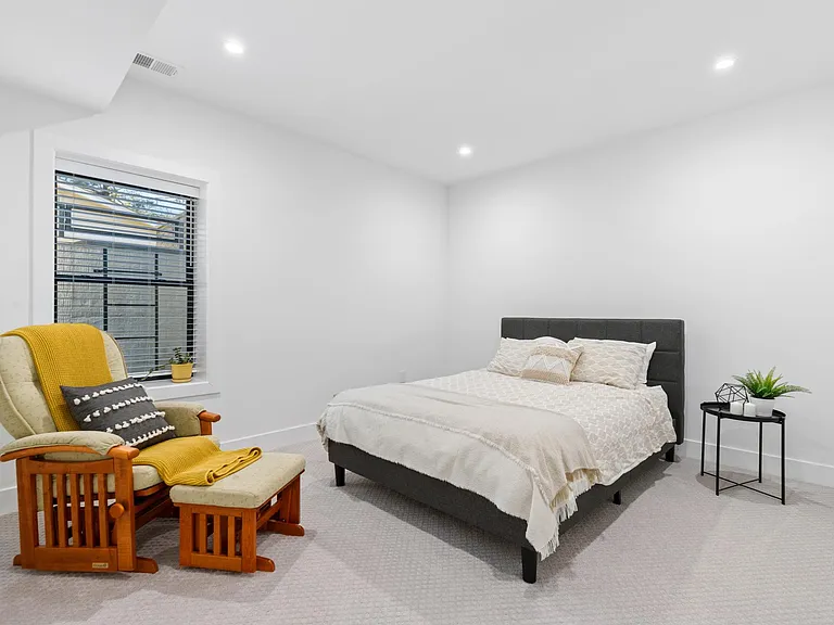 Bedroom A with a queen size bed and rocking chair