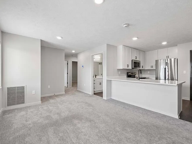An open-concept layout seamlessly connects the living and kitchen areas, creating a bright, inviting space for everyday living and entertaining.
