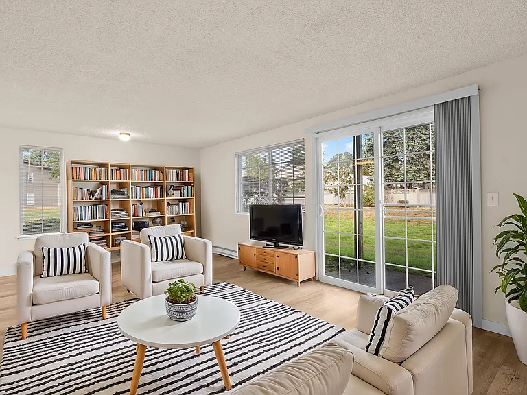 Experience tranquility in this beautifully designed living room with a scenic garden view.