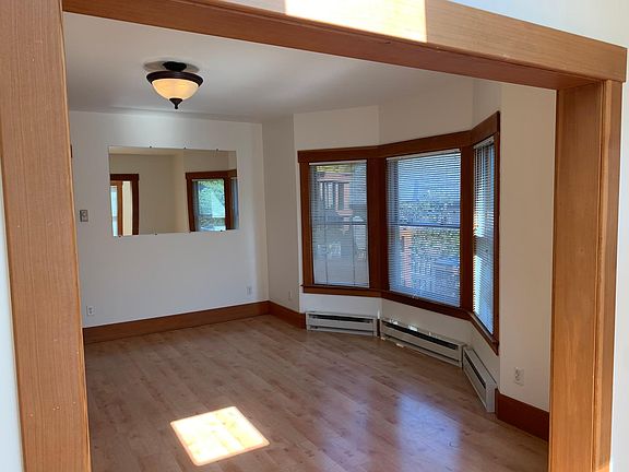 Looking at living room from entry. Nice bay windows