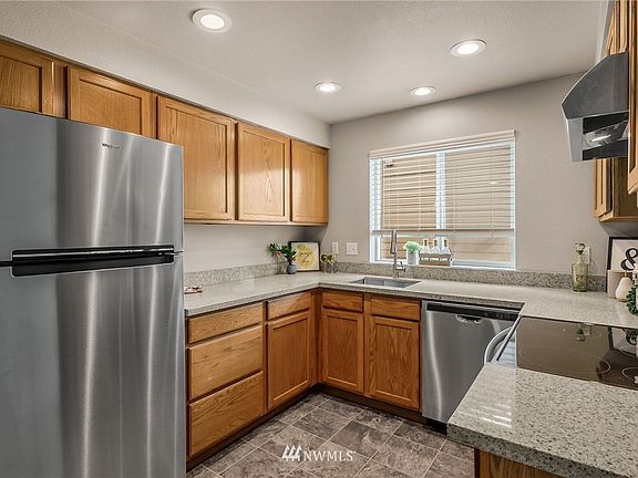 The well-appointed kitchen has been tastefully updated with new stainless appliances, stainless undermount sink, and new quartz counters. 