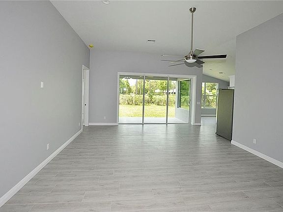 Main living area (taken from entry). Master bedroom is the door on the left; kitchen is to the right.