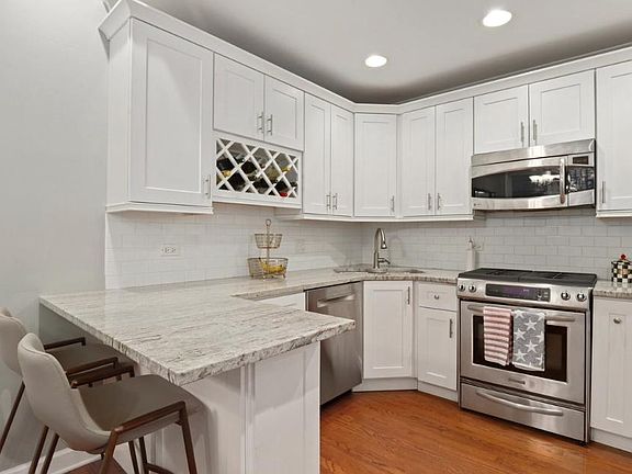 Kitchen with upgraded stainless appliances, granite counters/breakfast bar.