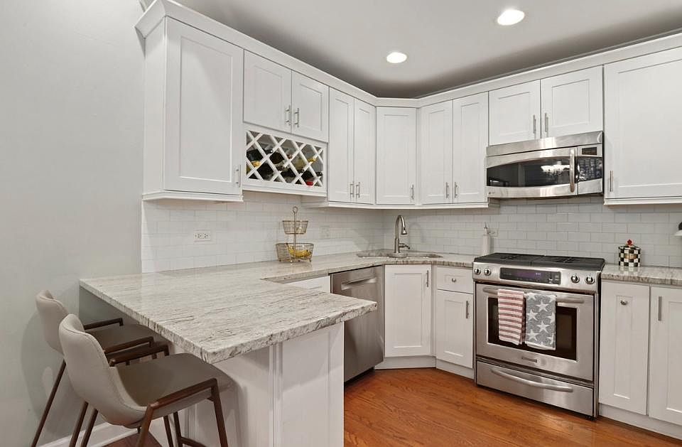Kitchen with upgraded stainless appliances, granite counters/breakfast bar.