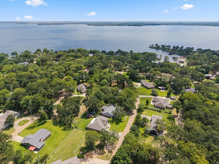 Expansive aerial perspective showcasing a residential area with significant tree coverage