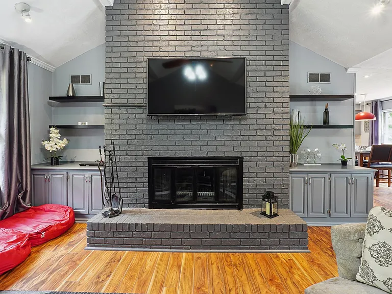 Living Room with TV, Fireplace & access to Garage & Upper Back Patio -Main Level