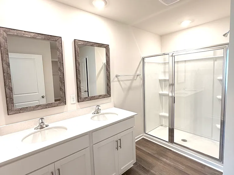 Master bath features a double sink, separate shower and large walk-in closet