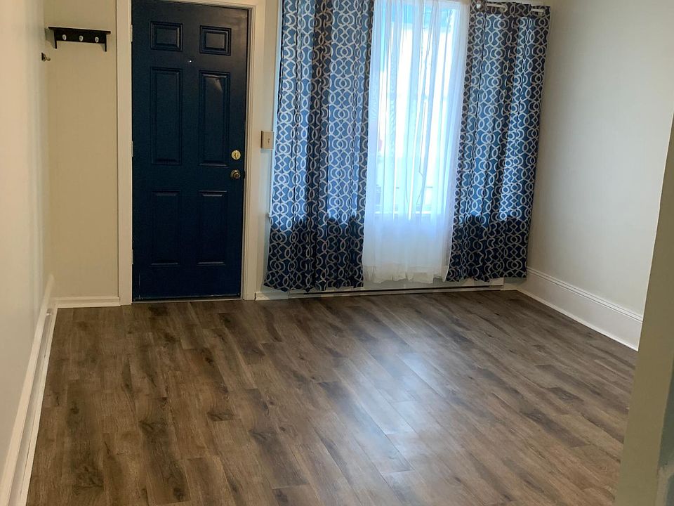 living room with front door entrance. new vinyl plank floors throughout 1st floor.