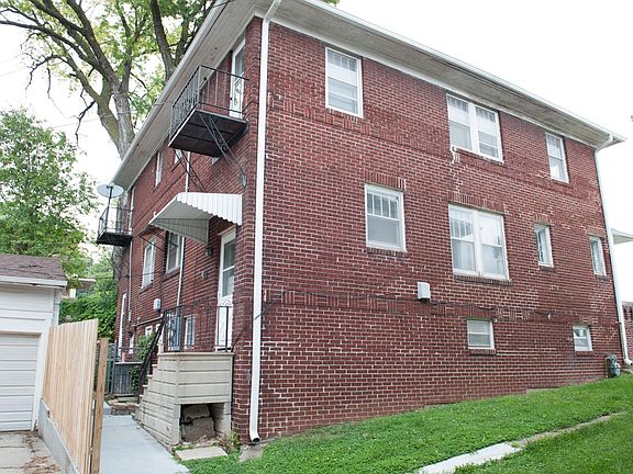 Rear side of home with parking garage.