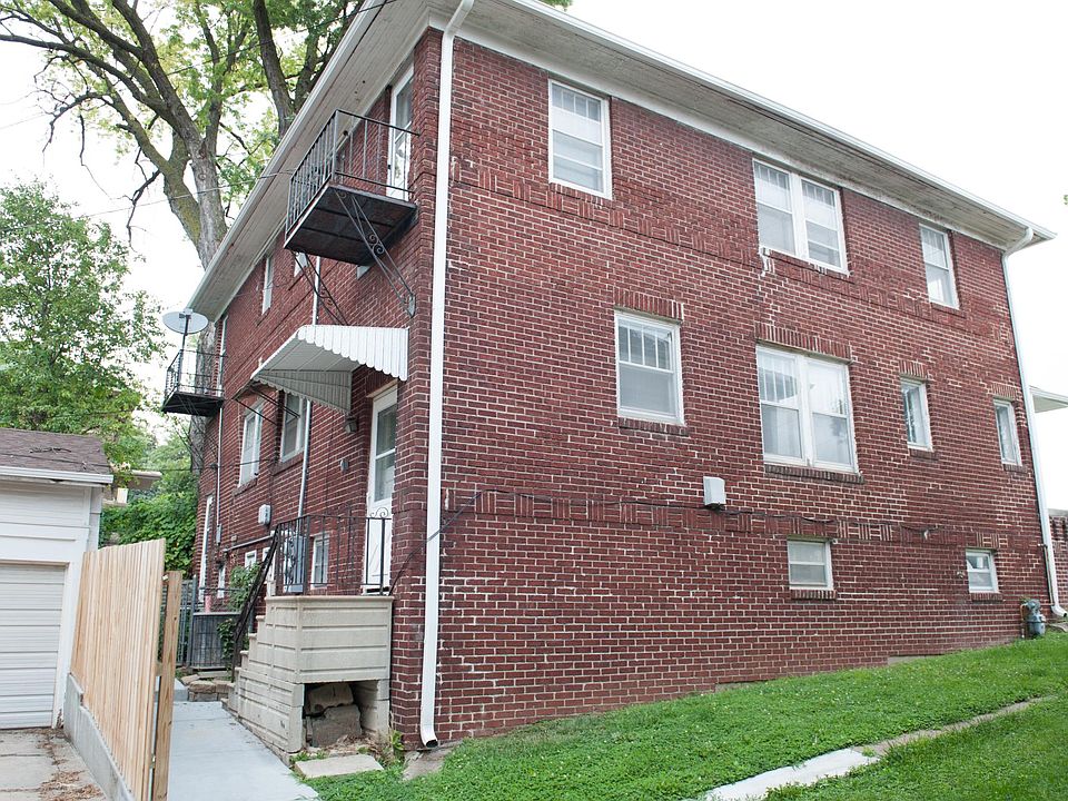 Rear side of home with parking garage.
