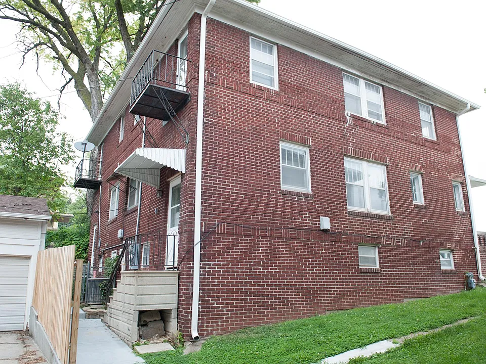 Rear side of home with parking garage.