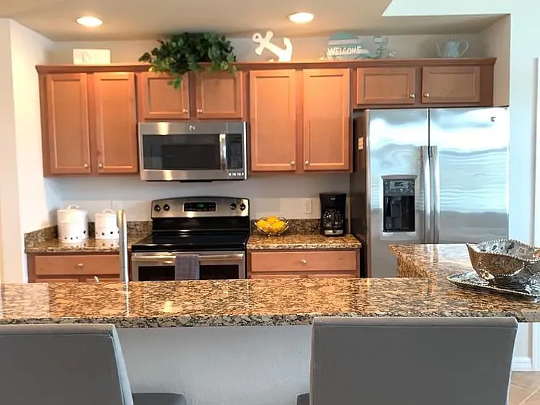 Eat up open kitchen area with new stainless steel appliances.