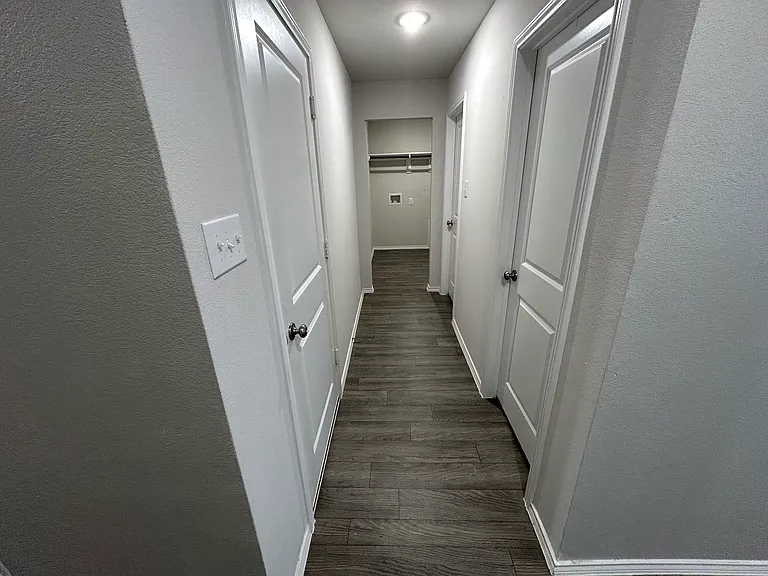 Hallway to washroom, garage, 3rd bedroom and bathroom