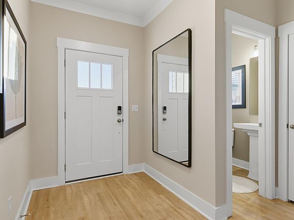 Stylish foyer of the Lawson floorplan with hardwood flooring and tasteful architectural detail in a