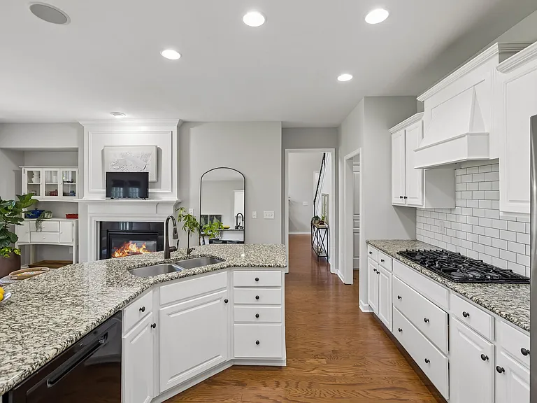 The chef's kitchen serves as the heart of the home, featuring generous prep space, an oversized island & abundant cabinetry. A reverse osmosis (RO) water filtration system is installed and will convey with the property!