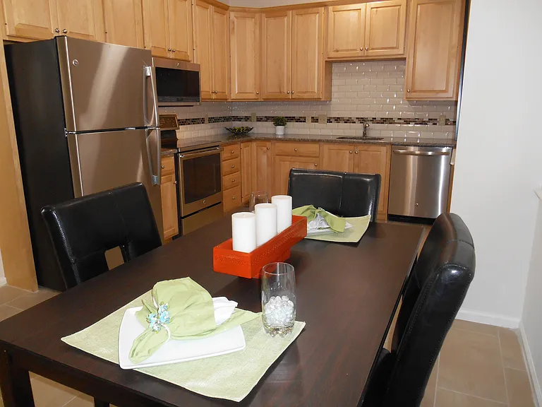 Upgraded stainless steel appliances in Henderson Square II kitchen with solid maple cabinetry. Breakfast nook.