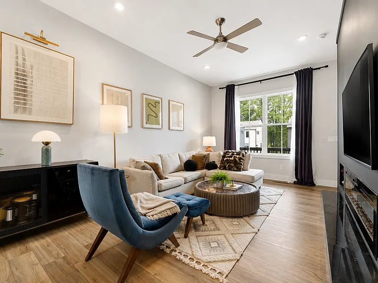 2nd view of living room showing one of two large windows and view of balcony