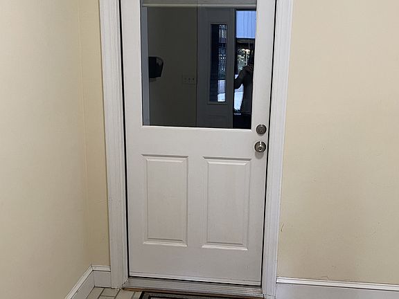 Entering from the backdoor, the apartment has it's private entrance. The custom shade on the inside of the door allows for privacy.