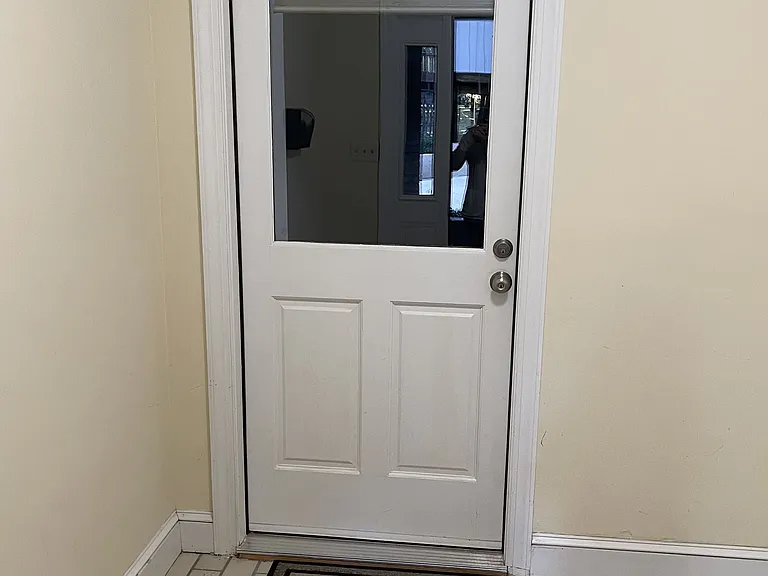 Entering from the backdoor, the apartment has it's private entrance. The custom shade on the inside of the door allows for privacy.