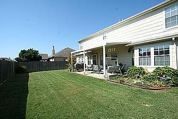 The backyard is landscaped & has a relaxing covered patio.