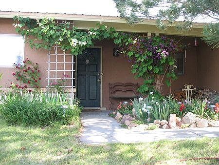 Front entry, porch, flower and herb garden.