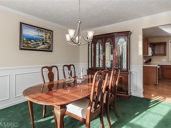 FORMAL DINING IS A ROOM YOU'LL BE PROUD OF; TRULY FORMAL W/CROWN MOLDING & WAINSCOT, UPDATED LIGHTIN