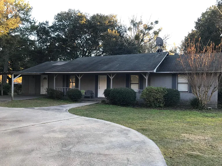 Front porch and paved driveway and parking space