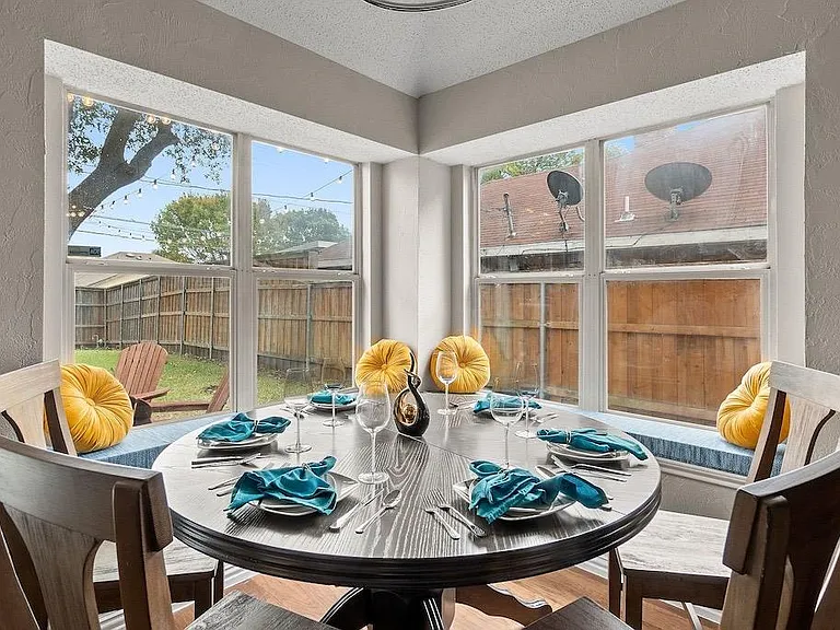 Very elegant dining room with high end dining table and chairs. Notice beautiful large window seats with custom seat cushions and accent pillows. All windows have dark out ultimate closure blinds not pictures.