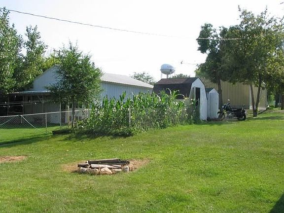 Backyard, fenced with garden area, fire pit and two sheds for storage. Corn is optional (garden area has excellent soil, tomatoes, potatoes, asparagus and brussel sprouts have all done well here).