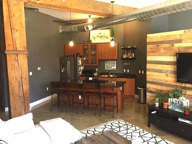 Open kitchen with stainless steel appliances and granite cou