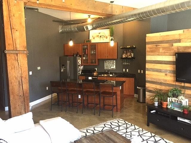 Open kitchen with stainless steel appliances and granite cou