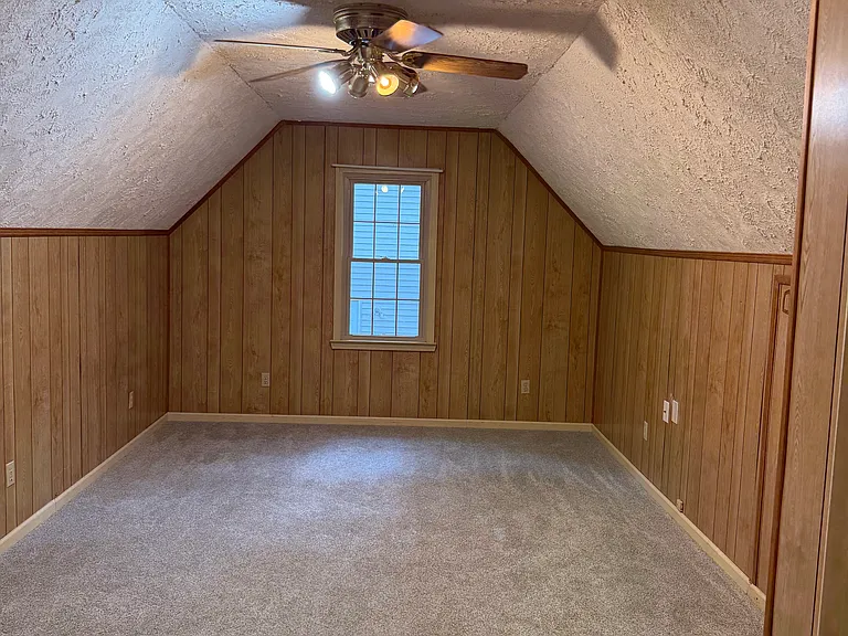 FROG (Full Room Over Garage) with large closet, fully carpeted, and access to attic storage.