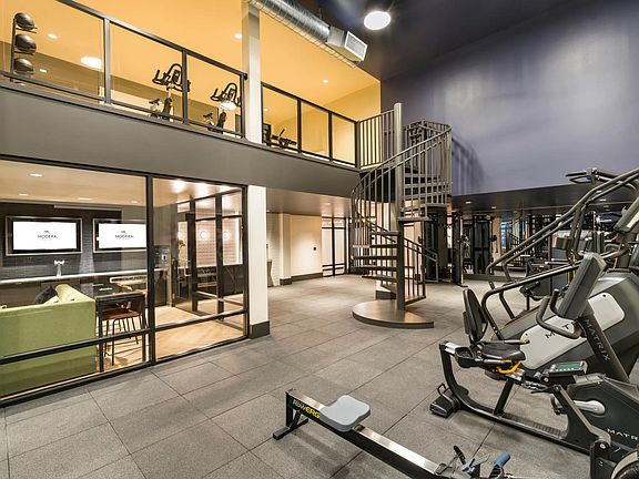 Stay active with ease in the two-level fitness studio at Modera Beaverton, featuring cutting-edge equipment and contemporary design.
