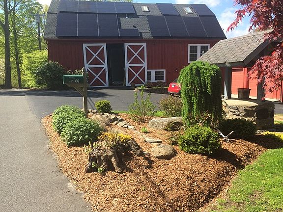 Barn with solar panels and beautiful plantings