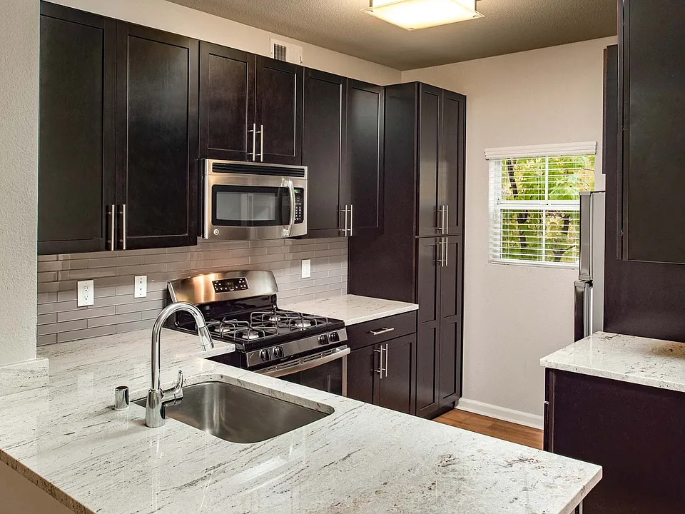 Modern kitchen with stainless steel appliances, granite countertops and premium cabinetry