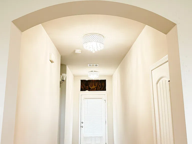 Foyer/hallway with modern chandelier