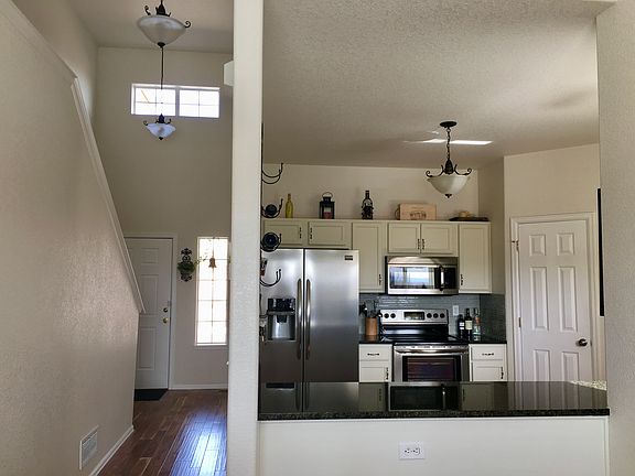 Hallway access from front entrance, living room, stairway, and kitchen.