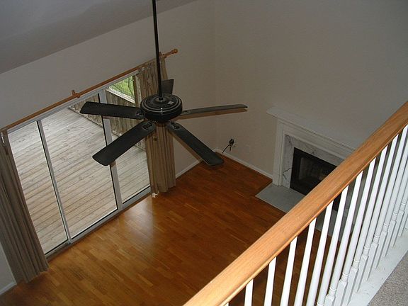 Family room has hardwood floors, vaulted ceiling, and gaslog fireplace.