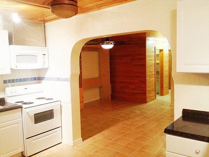 Kitchen with view of living room and closets