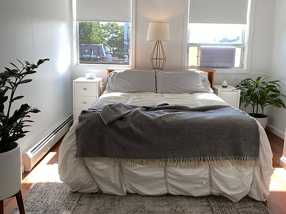 Large bedroom with 2 windows and 2 closets. South Eastern exposure with lots of natural light. Custom black out curtains installed.