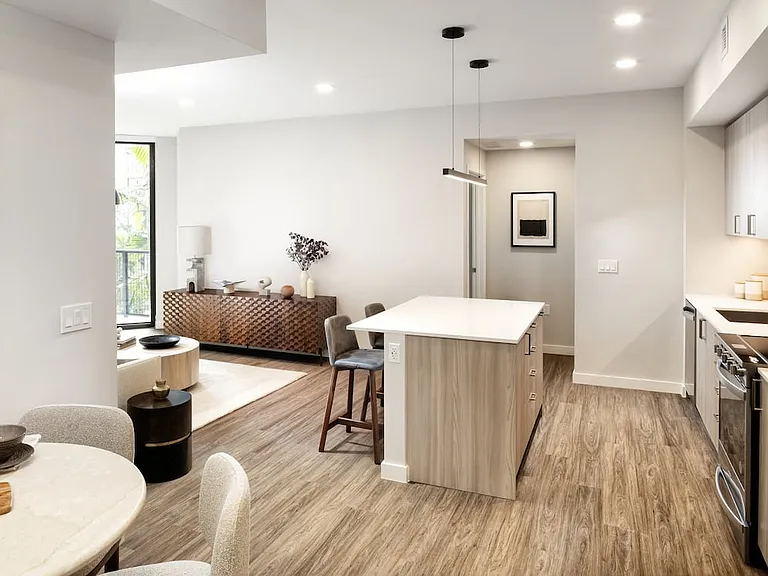 Upgrade Collection I kitchen with light wood cabinetry, white quartz countertops, and stainless steel appliances