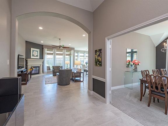 The extended entry continues past the dining room towards the warm and inviting family room and kitchen area.