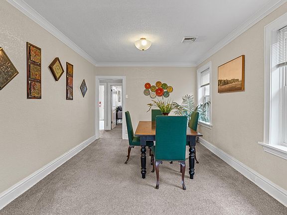 Charming dining room featuring stylish blue chairs, creating a vibrant and inviting ambiance.