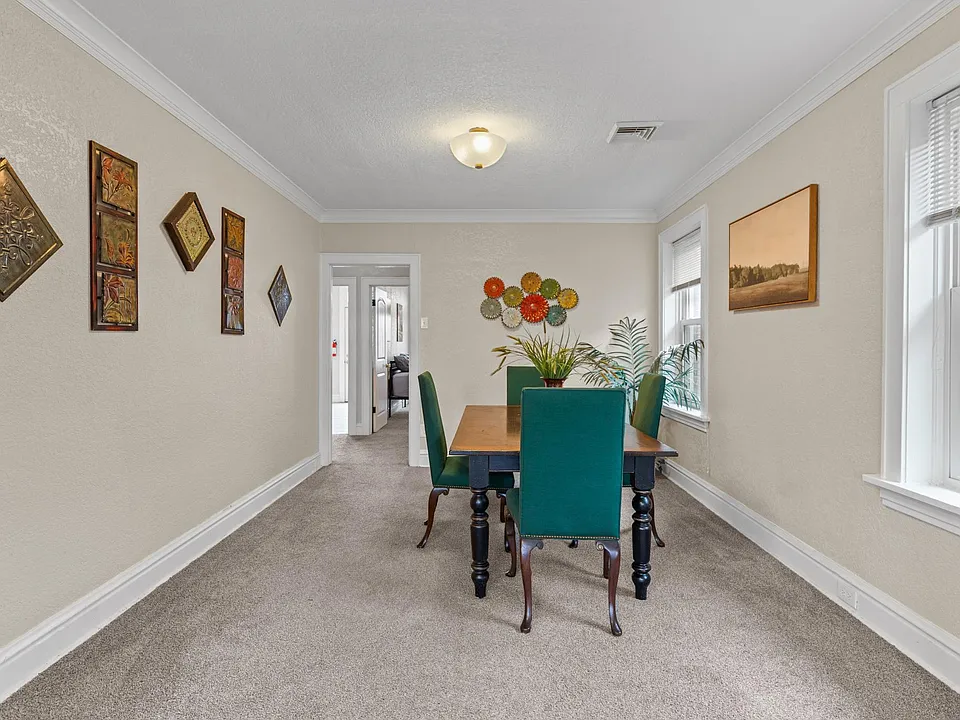Charming dining room featuring stylish blue chairs, creating a vibrant and inviting ambiance.
