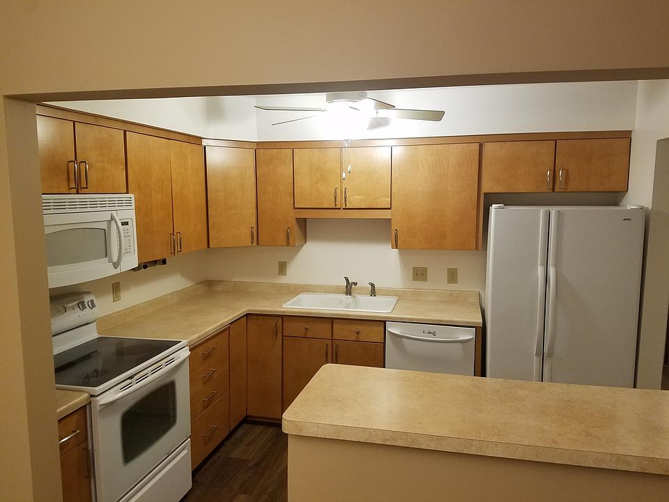 New wood floors in kitchen with bar and open area to dining room and living room.