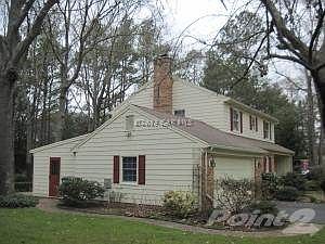 Garage side home with view of workshop