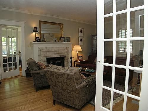 living room w/ parlour doors & fireplace