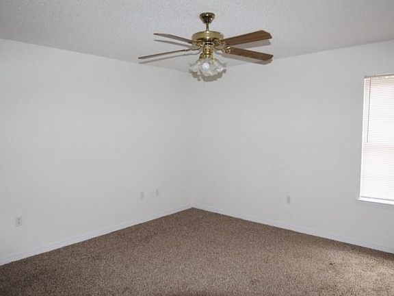 Large living room with vaulted ceiling. New carpet.